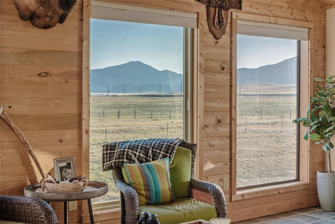 465 Litmer Road Jefferson, CO 80456 - Photo 13 of 50 Sitting room featuring a mountain view, wood walls, and a view of countryside