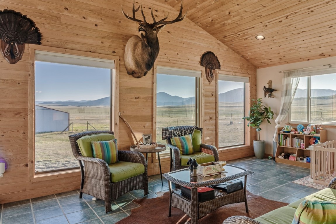 465 Litmer Road Jefferson, CO 80456 - Photo 14 of 50 Sunroom with vaulted ceiling and a mountain view