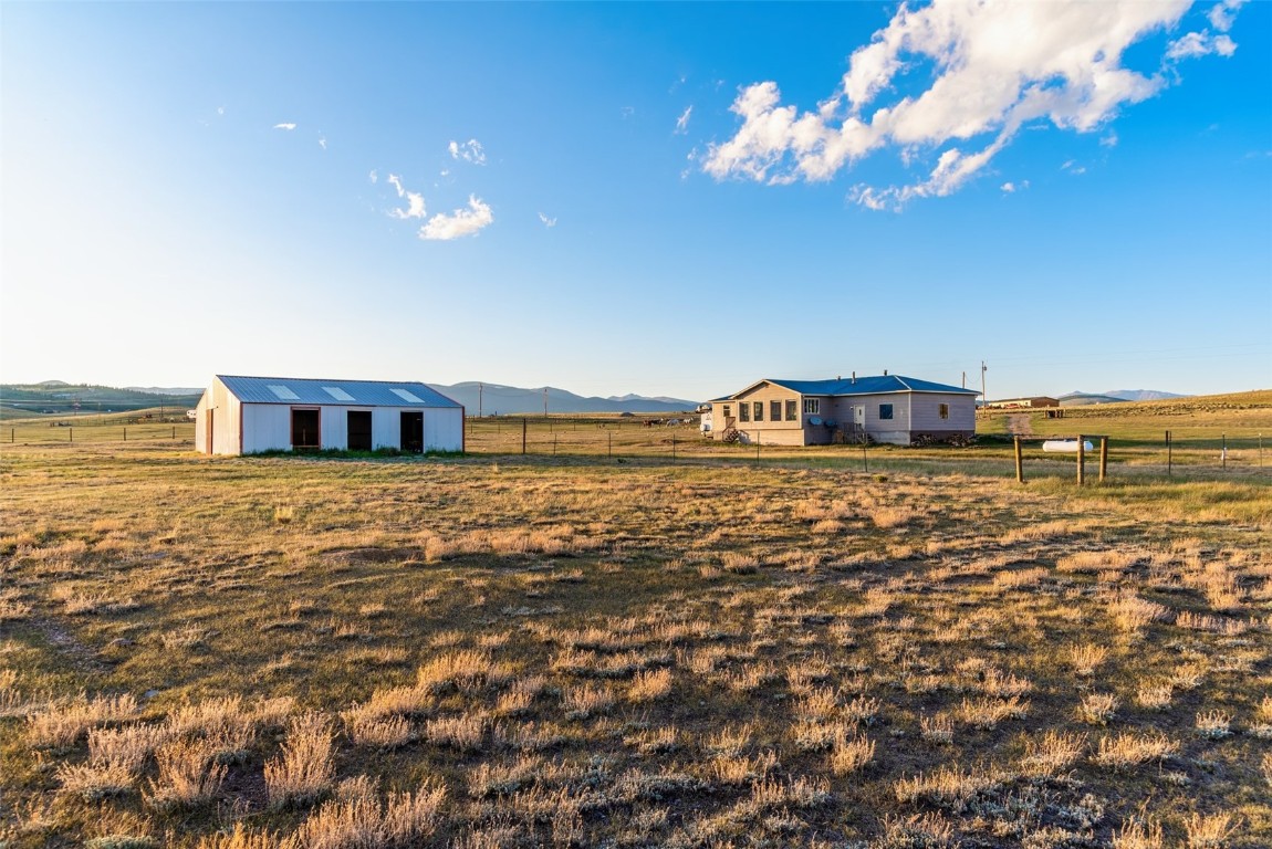 465 Litmer Road Jefferson, CO 80456 - Photo 21 of 50 View of yard with a view of rural / pastoral area, an outbuilding, a mountain view, and an outdoor structure