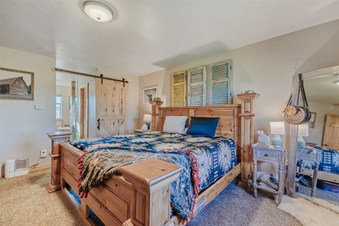 465 Litmer Road Jefferson, CO 80456 - Photo 30 of 50 Carpeted bedroom with a barn door
