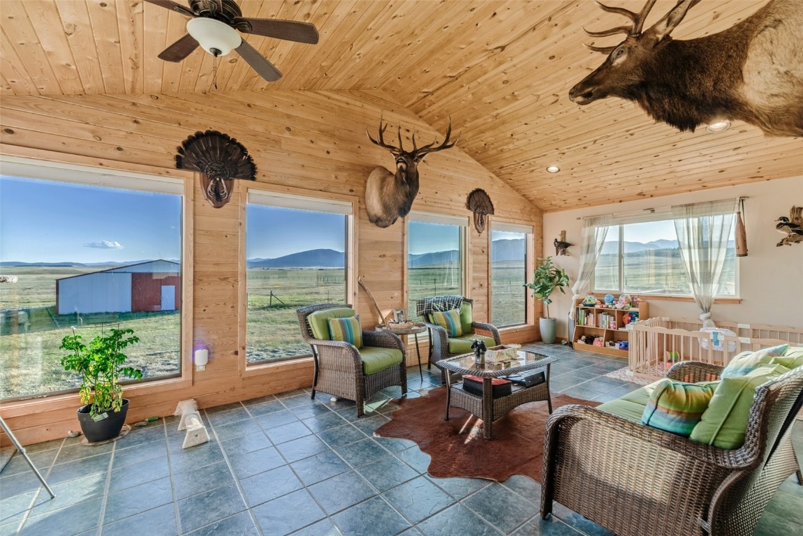 465 Litmer Road Jefferson, CO 80456 - Photo 3 of 50 Sunroom with lofted ceiling and a mountain view