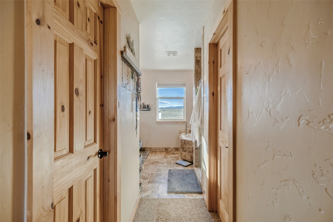 465 Litmer Road Jefferson, CO 80456 - Photo 34 of 50 Bathroom with a bathtub and stone finish floors