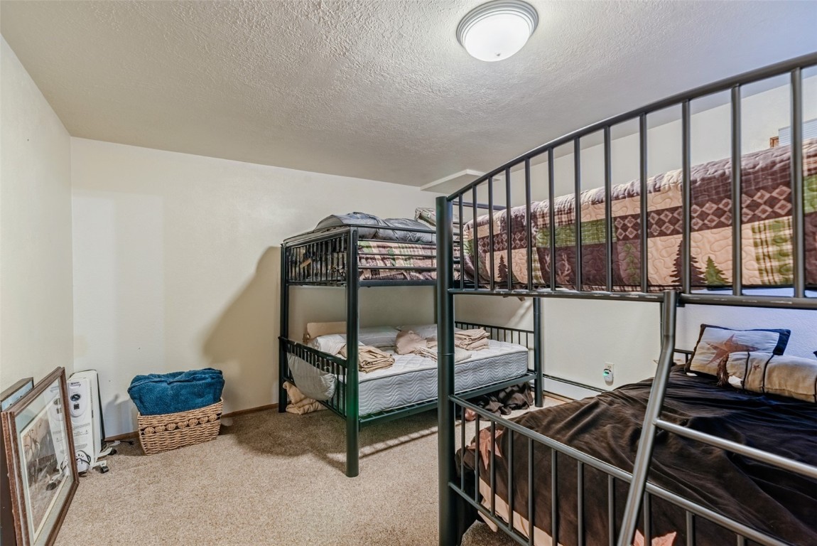 465 Litmer Road Jefferson, CO 80456 - Photo 36 of 50 Carpeted bedroom with a textured ceiling and baseboard heating