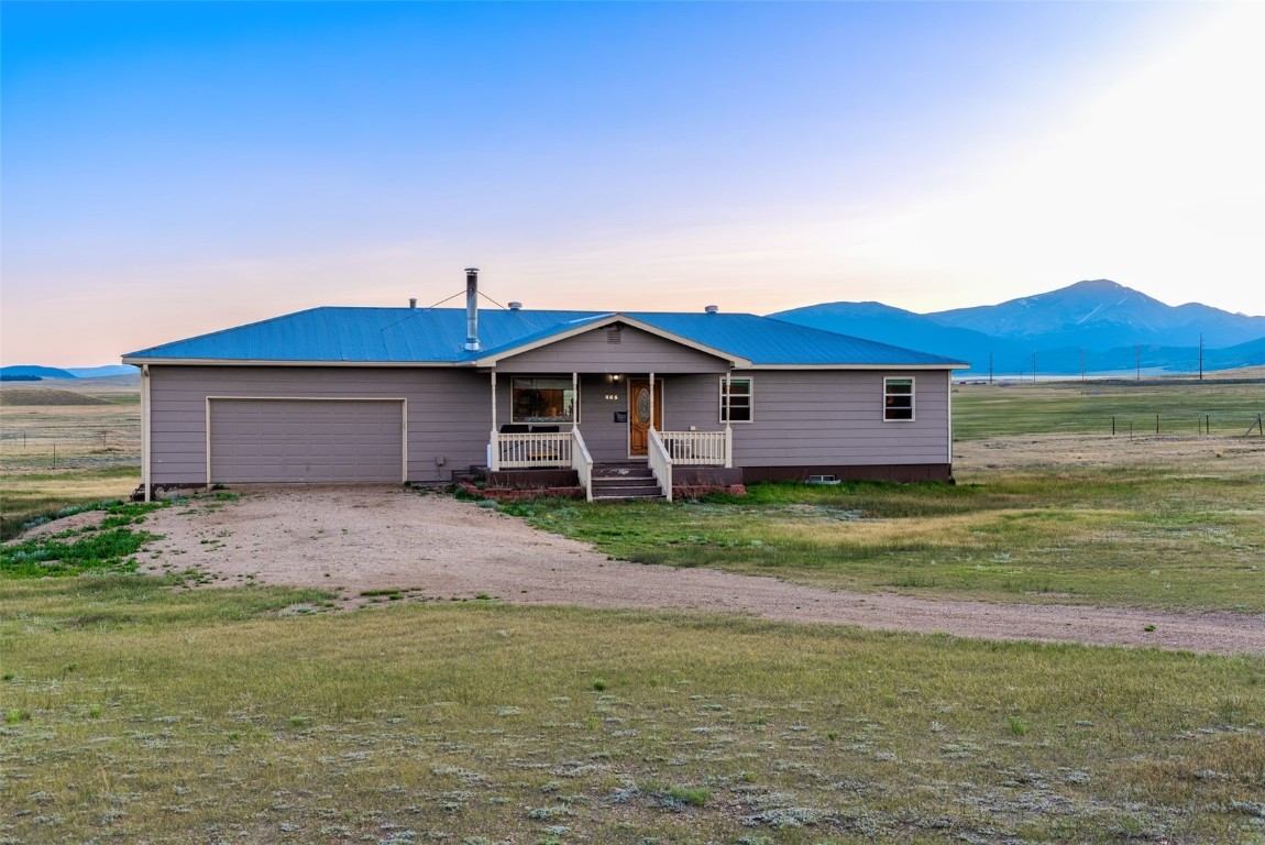 465 Litmer Road Jefferson, CO 80456 - Photo 48 of 50 View of front facade with covered porch, an attached garage, driveway, and a metal roof