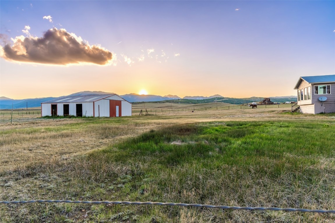 465 Litmer Road Jefferson, CO 80456 - Photo 49 of 50 View of yard featuring a pole building, a garage, an outdoor structure, and a view of rural / pastoral area