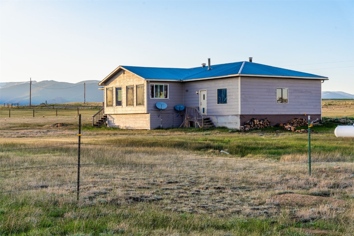465 Litmer Road Jefferson, CO 80456 - Photo 50 of 50 Back of house with a mountain view, a metal roof, and a rural view