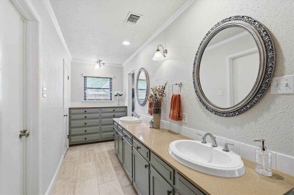 7200 Tamarack Road Benbrook, TX 76116 - Photo 21 of 38 Primary bathroom featuring a dual vanity, built-in dresser drawers, and extended countertops.