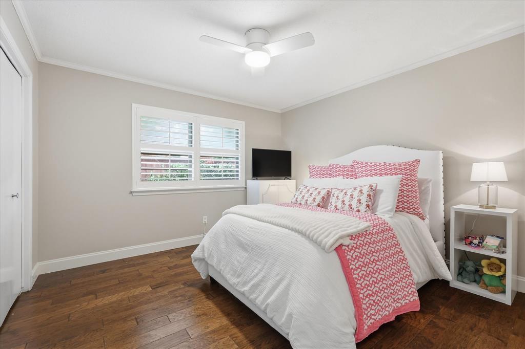7200 Tamarack Road Benbrook, TX 76116 - Photo 25 of 38 Bedroom #3 featuring wood-finish flooring, a double window with white blinds, a white ceiling fan, and crown molding.