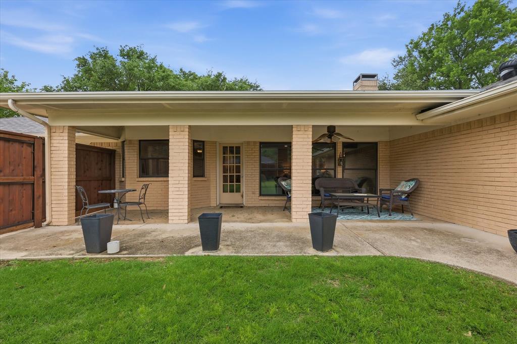 7200 Tamarack Road Benbrook, TX 76116 - Photo 30 of 38 Extended covered patio featuring a ceiling fan, and brick pillars.