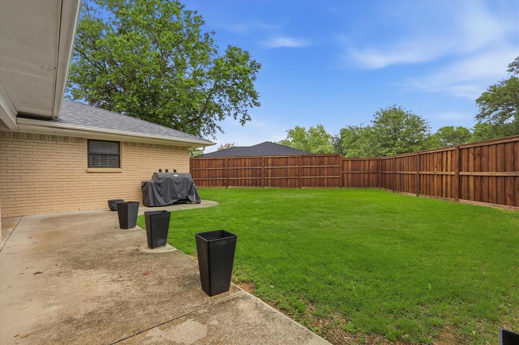 7200 Tamarack Road Benbrook, TX 76116 - Photo 31 of 38 Expansive backyard featuring new wood privacy fencing, and a concrete patio.