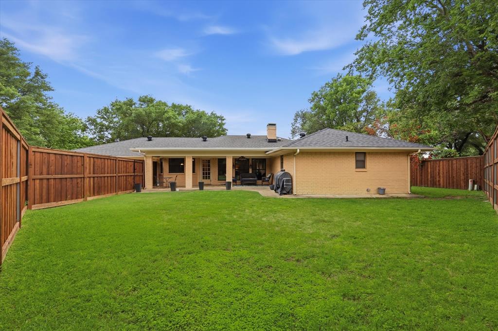 7200 Tamarack Road Benbrook, TX 76116 - Photo 32 of 38 Expansive backyard featuring a lush lawn, new privacy fencing, and a covered patio.