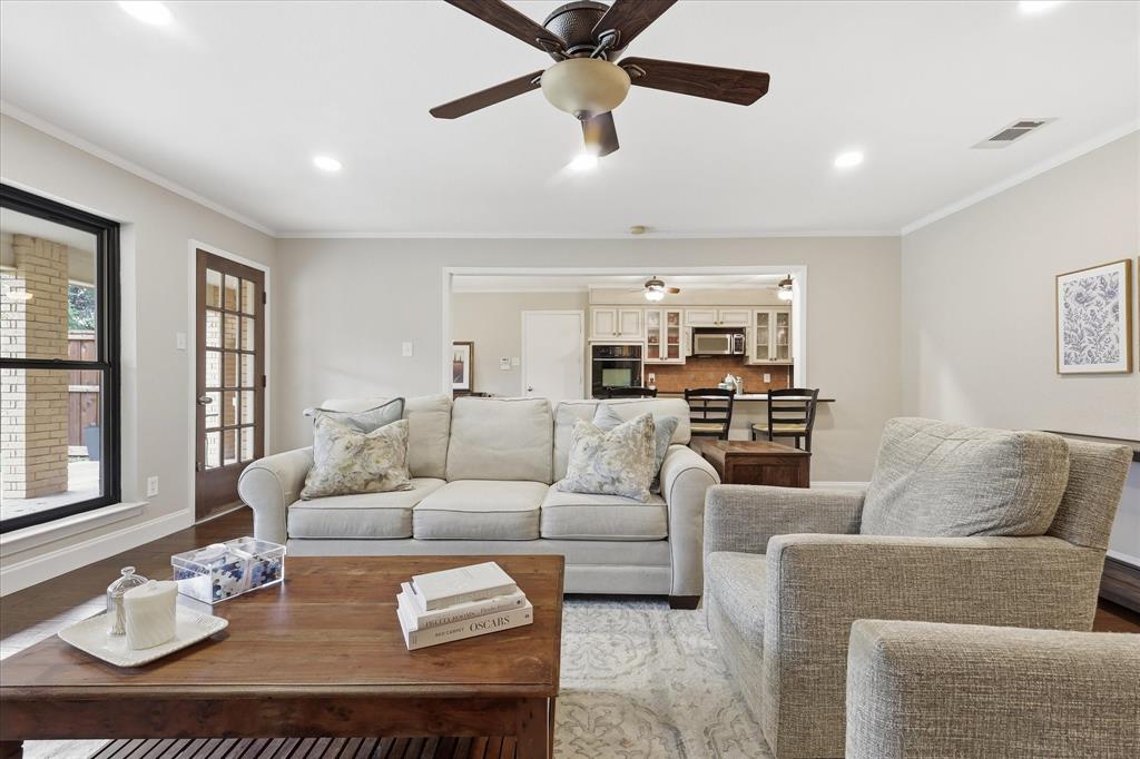 7200 Tamarack Road Benbrook, TX 76116 - Photo 7 of 38 Living room with wood-finish flooring, recessed lighting, crown molding, and a ceiling fan.