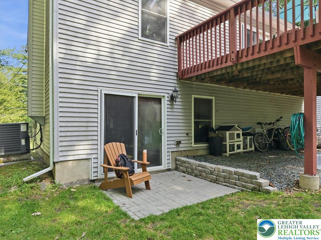 128 Chestnut Street Dingmans Ferry, PA 18328 - Photo 32 of 43 A private ground-level patio offers a serene outdoor retreat under a second-story deck.