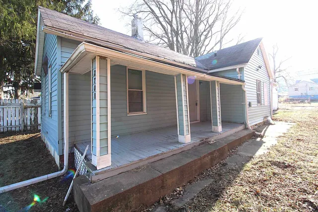 a view of house with backyard