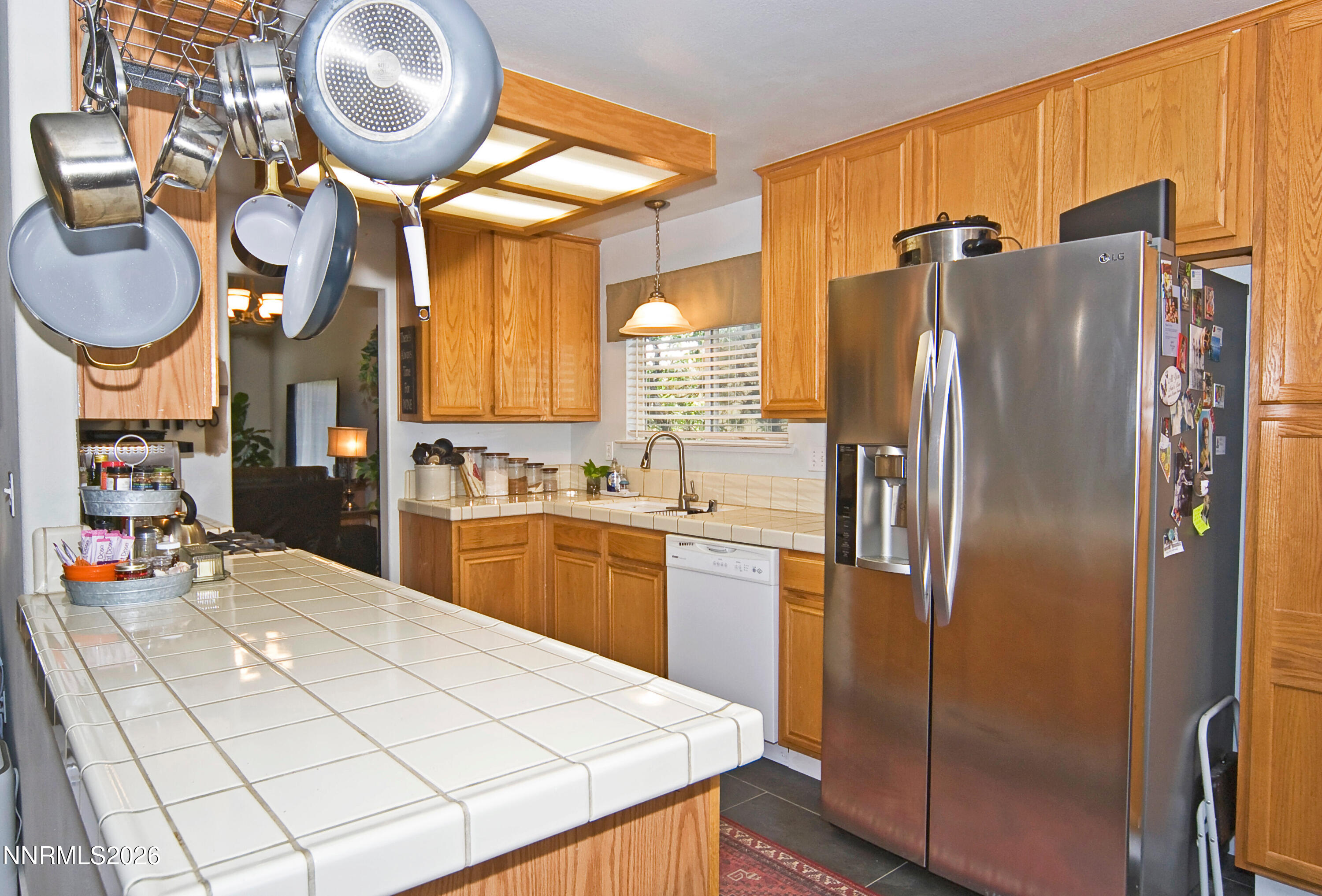 3289 Epic Avenue Reno, NV 89512 - Photo 15 of 32 a kitchen with stainless steel appliances a refrigerator a stove a sink and a large window