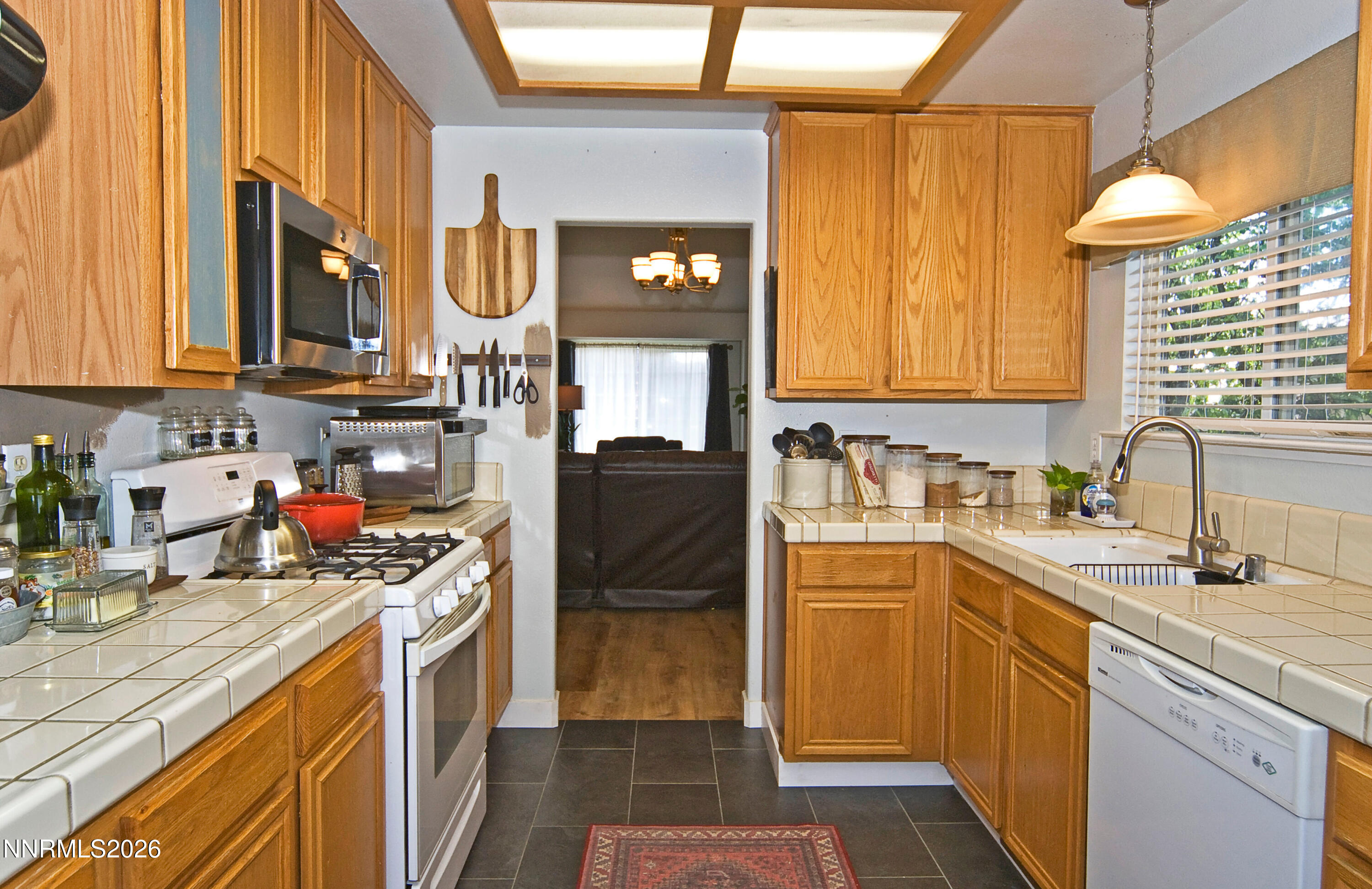 3289 Epic Avenue Reno, NV 89512 - Photo 16 of 32 a kitchen with stainless steel appliances granite countertop a sink and cabinets