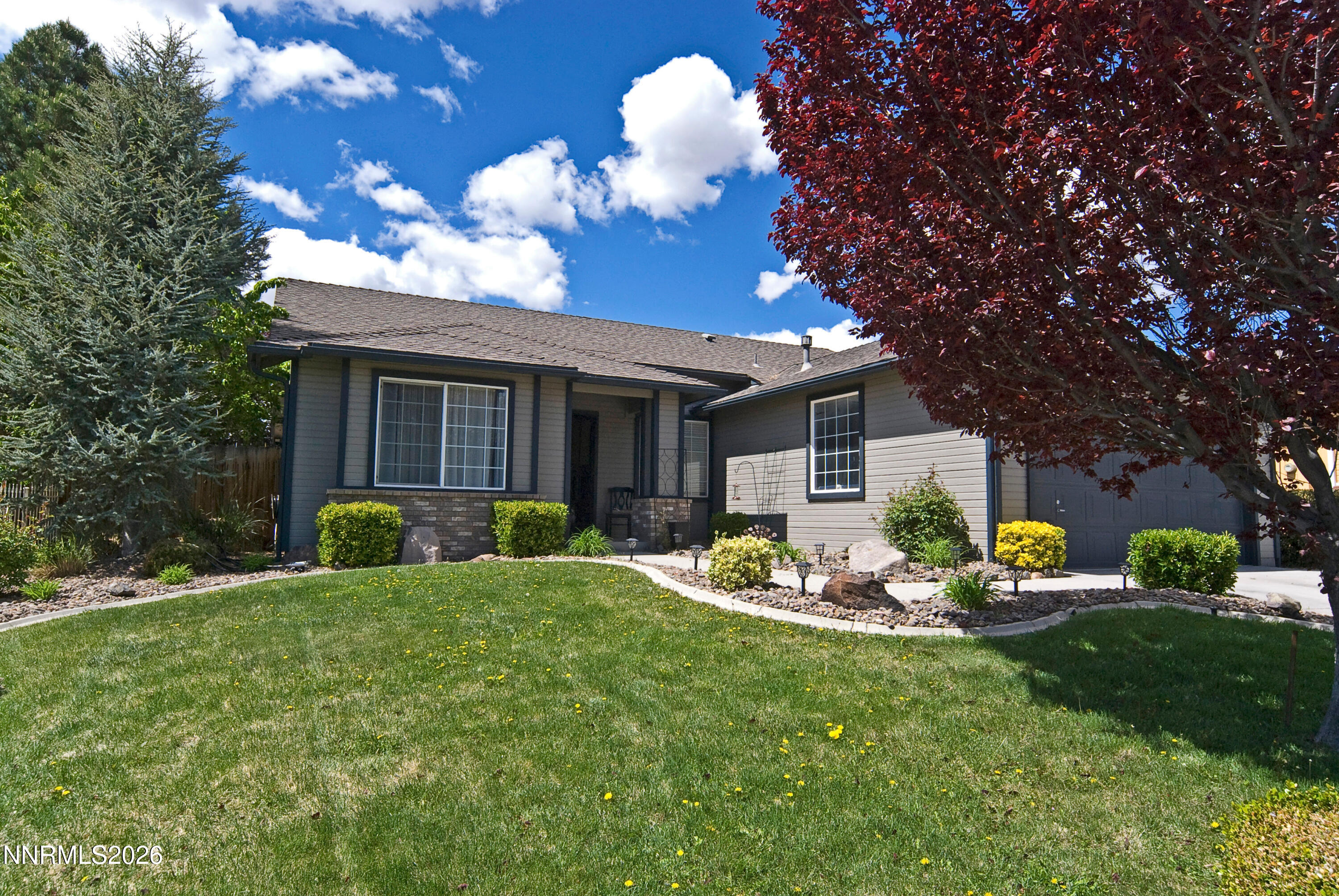 3289 Epic Avenue Reno, NV 89512 - Photo 2 of 32 a front view of a house with garden and porch
