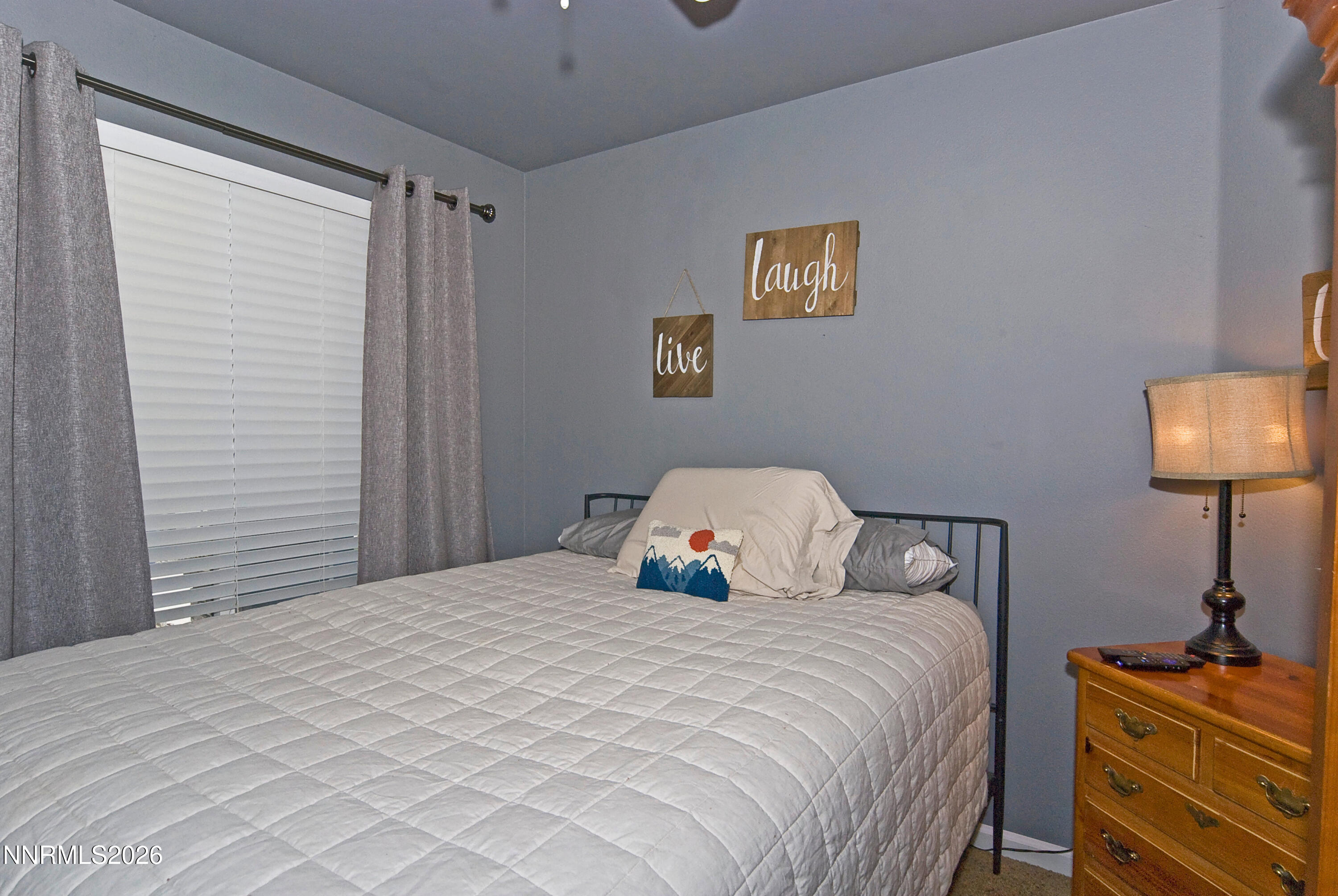 3289 Epic Avenue Reno, NV 89512 - Photo 23 of 32 a bedroom with a bed and a lamp on the dresser
