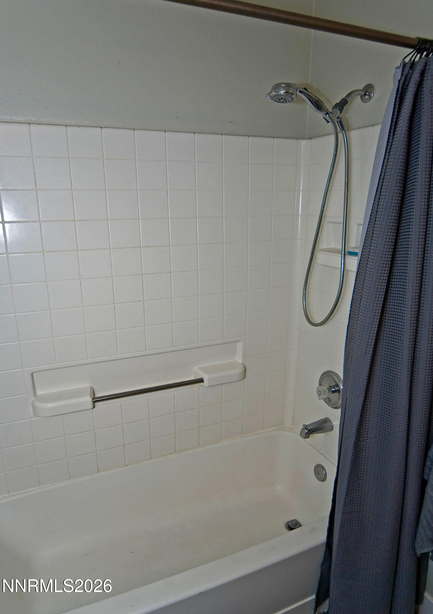 3289 Epic Avenue Reno, NV 89512 - Photo 26 of 32 a bathroom with a bath tub and a shower