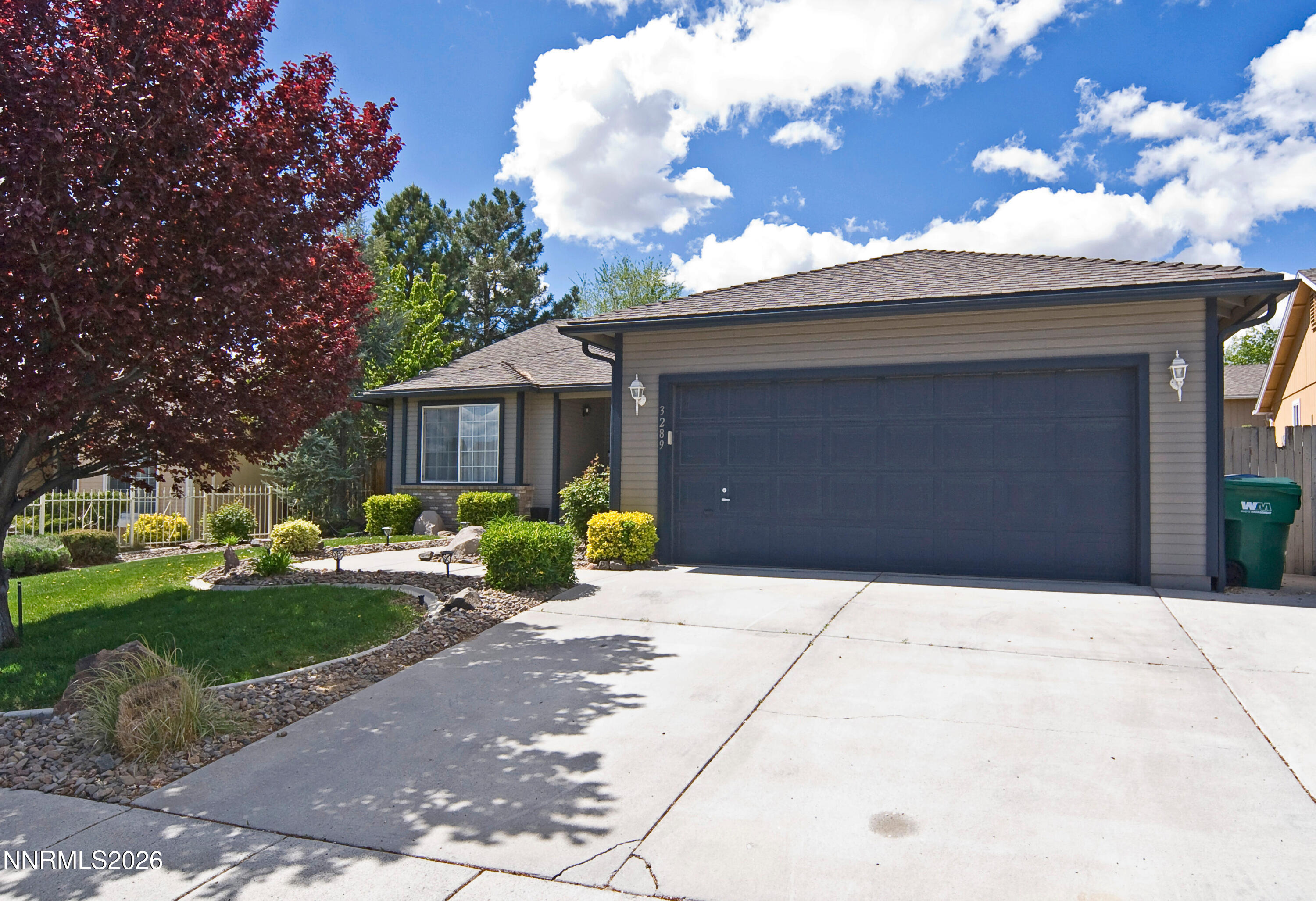 3289 Epic Avenue Reno, NV 89512 - Photo 4 of 32 a front view of a house with a yard and garage