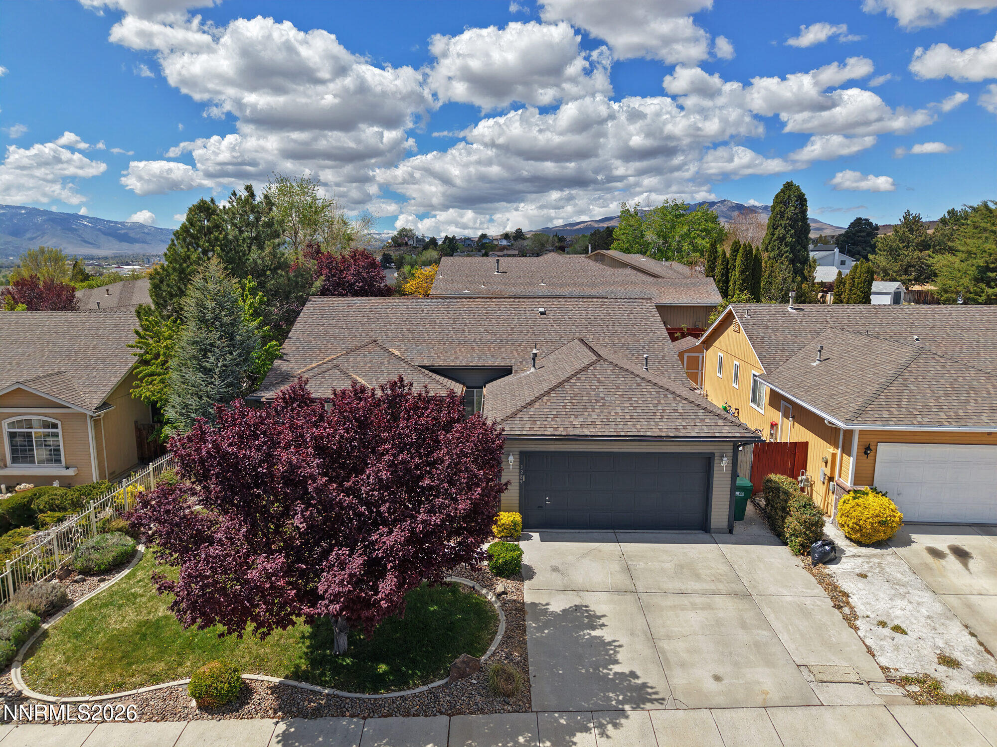 3289 Epic Avenue Reno, NV 89512 - Photo 5 of 32 a front view of a house with a yard and potted plants