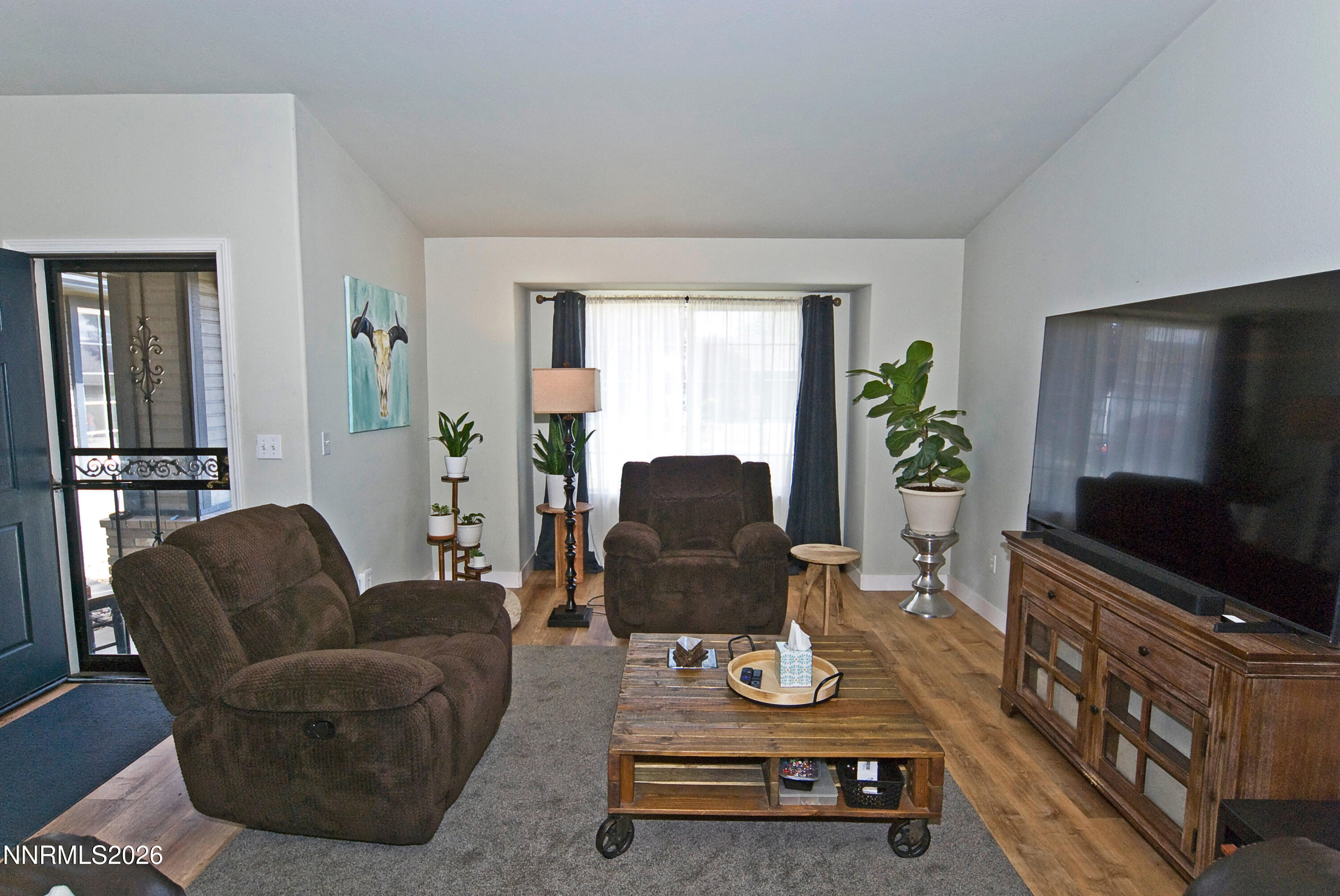3289 Epic Avenue Reno, NV 89512 - Photo 9 of 32 a living room with furniture and a flat screen tv