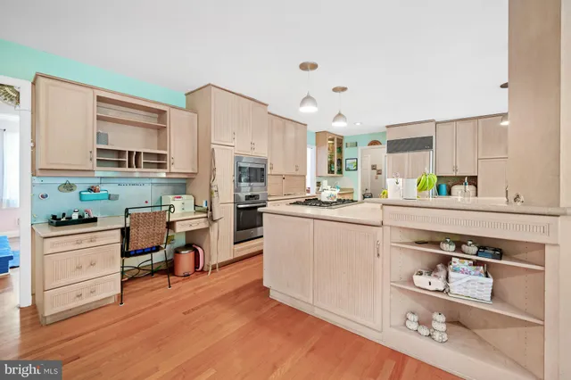 a kitchen with stainless steel appliances a refrigerator sink and cabinets