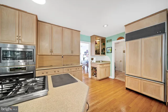 a kitchen with stainless steel appliances a refrigerator sink and cabinets