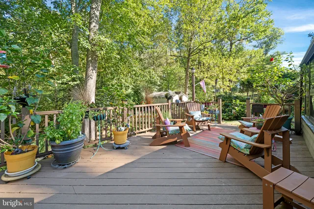 a view of a deck with chairs a barbeque with wooden floor