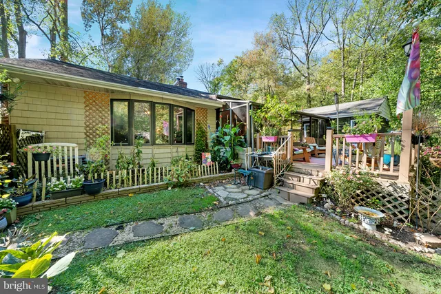 a living room with furniture a rug and a floor to ceiling window