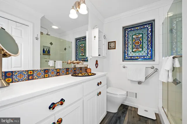 a bathroom with a toilet a sink and shower