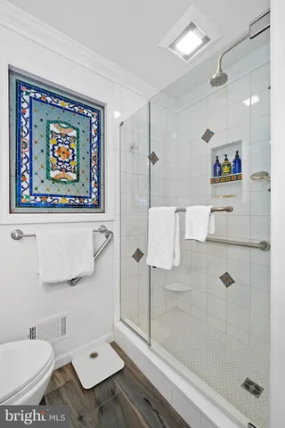 a view of an empty room with closet area and window