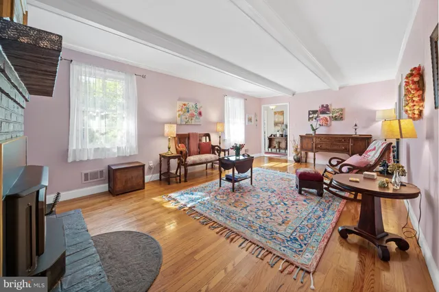 a living room with furniture rug and window
