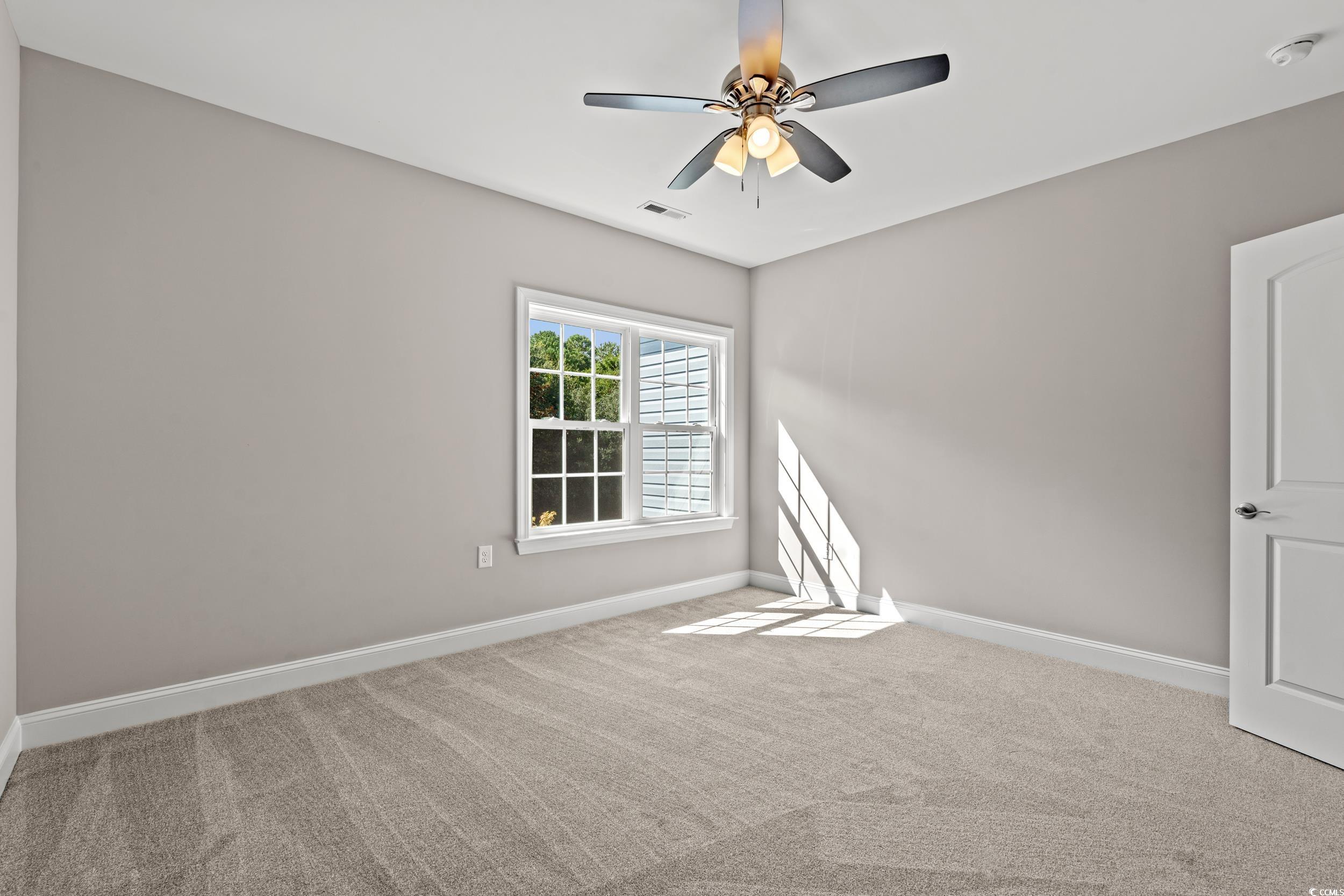 344 Kiskadee Loop, Unit B Conway, SC 29526 - Photo 18 of 32 Empty room with ceiling fan and carpet flooring