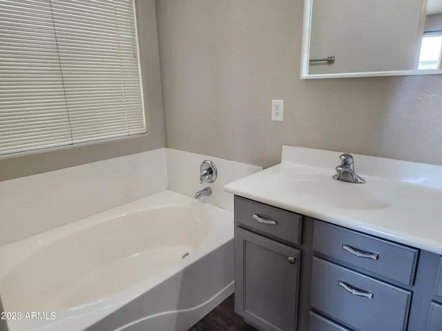 a bathroom with a bathtub and a sink