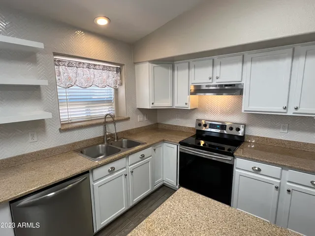 a kitchen with a sink stove and cabinets