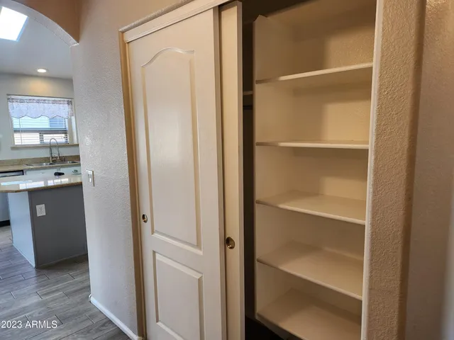 a view of walk in closet with empty racks