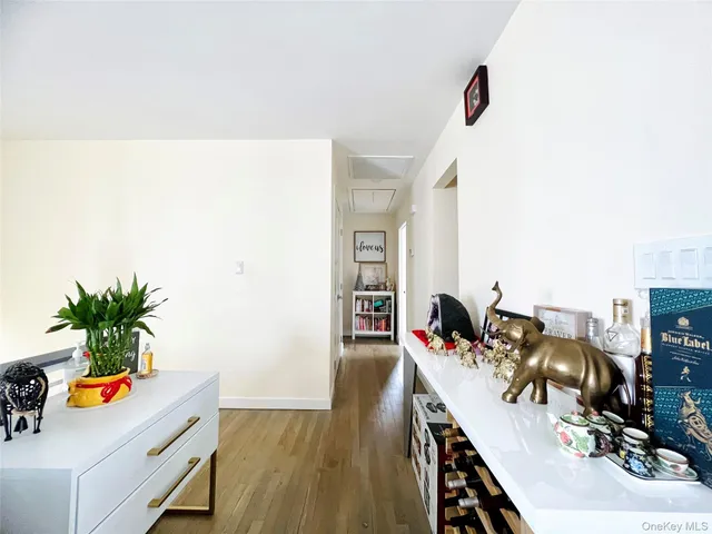 a hallway with a potted plant on the counter and cabinets