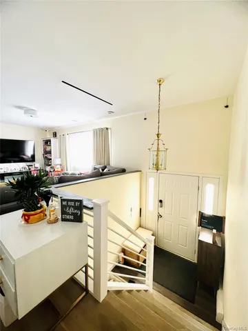 a kitchen with stainless steel appliances refrigerator stove and wooden floor
