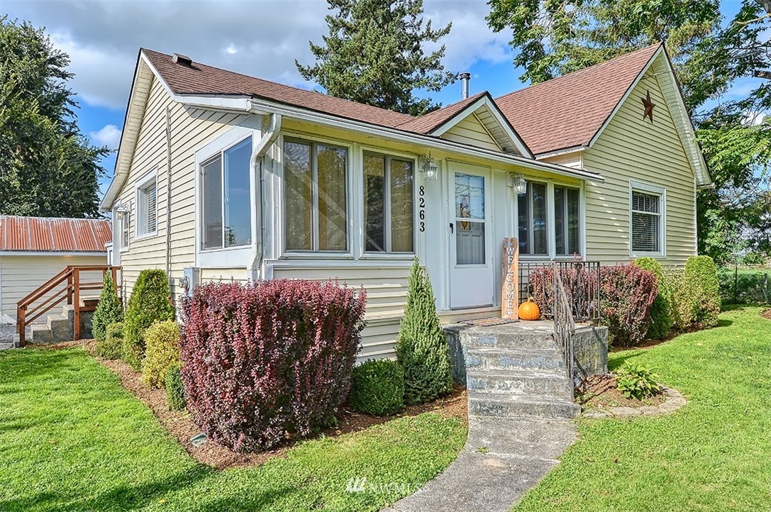 8263 Nooksack Road Everson, WA 98247 - Photo 1 of 36 a front view of a house with garden