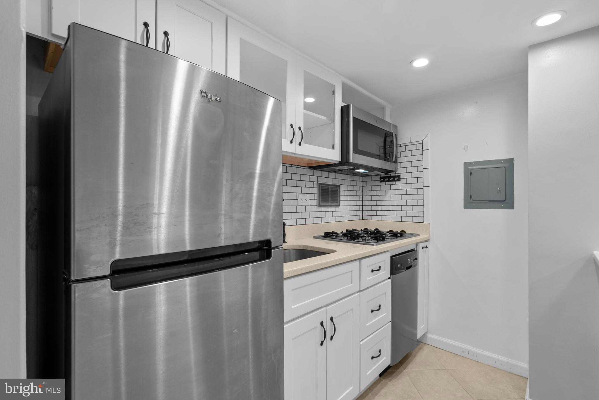 1420 N Street Northwest, Unit 914 Washington, DC 20005 - Photo 6 of 23 a kitchen with stainless steel appliances granite countertop a refrigerator and a stove