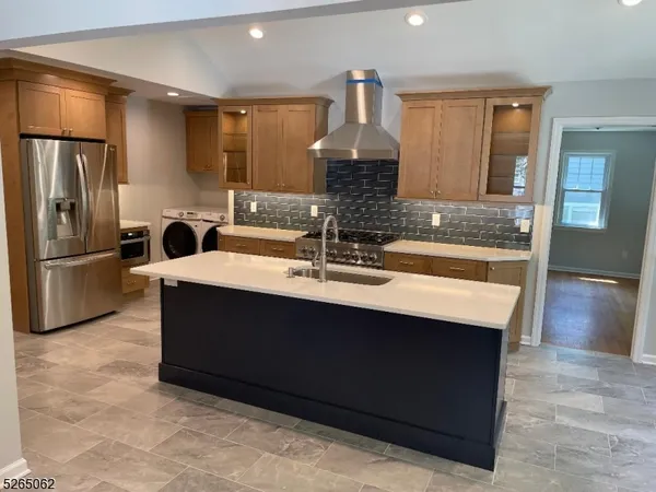 a kitchen with sink refrigerator and microwave