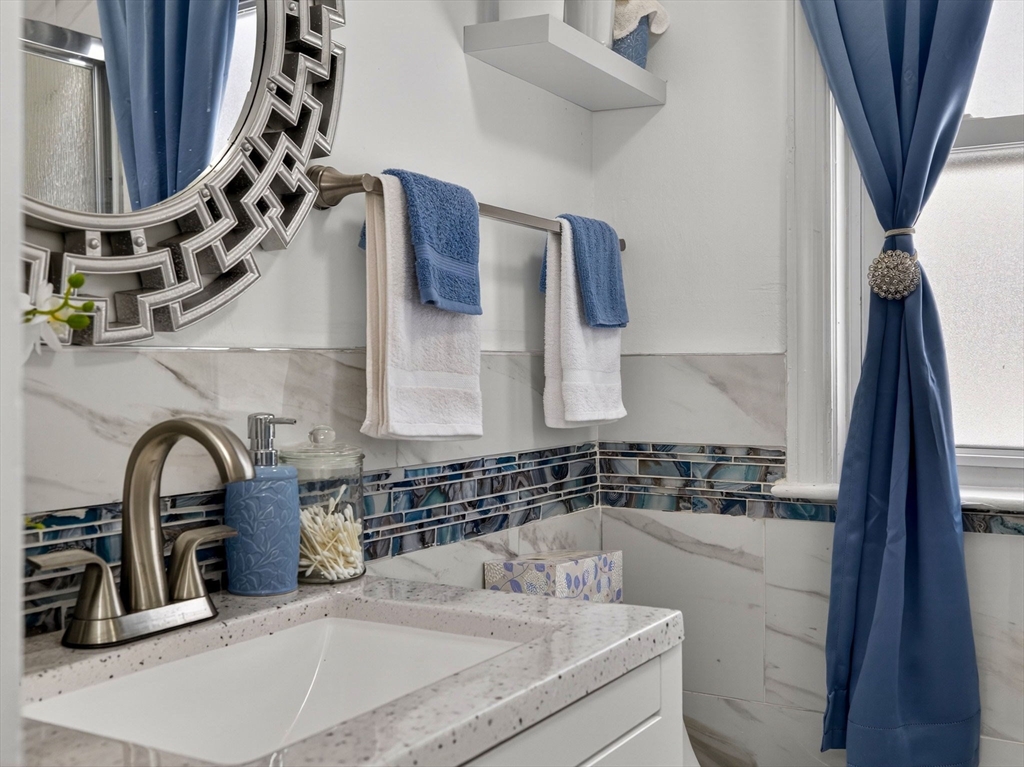 19 Melba Way Boston, MA 02136 - Photo 15 of 34 a bathroom with a sink and a mirror