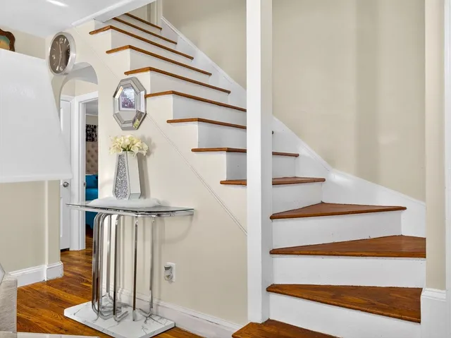 a view of entryway and hall with wooden floor