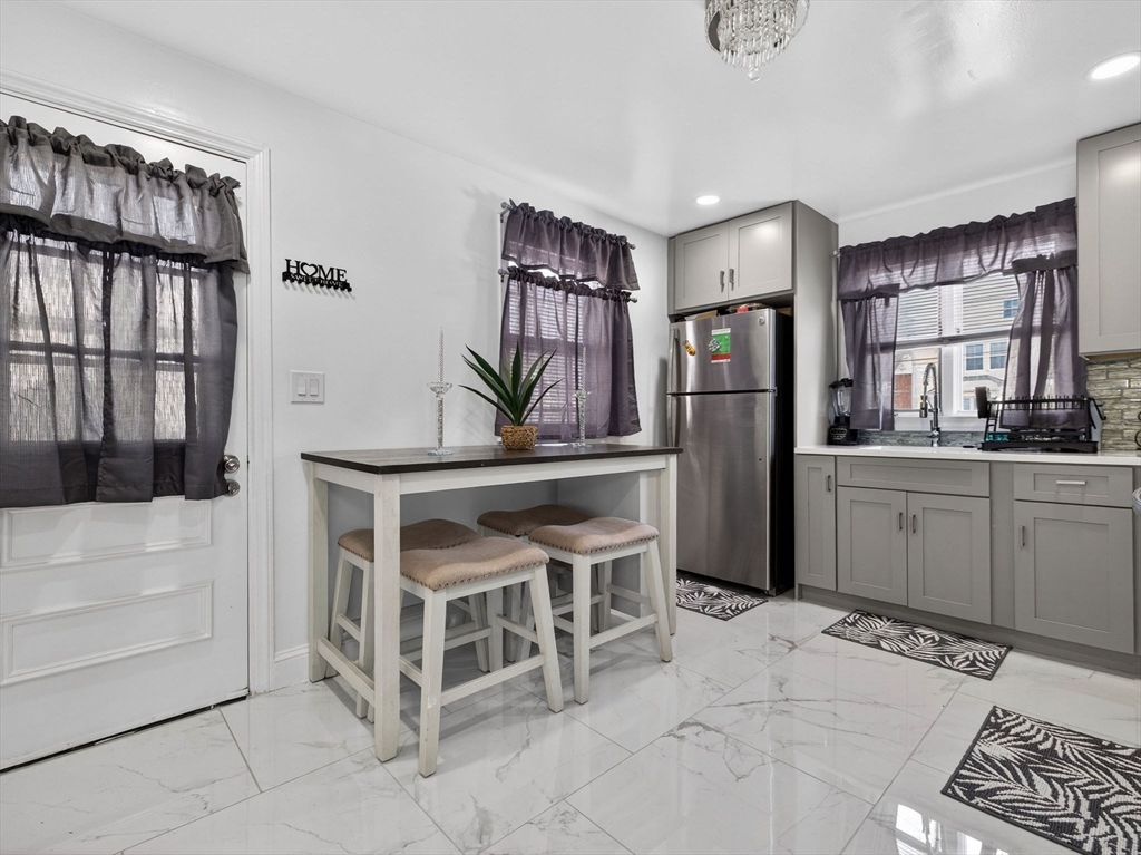 19 Melba Way Boston, MA 02136 - Photo 9 of 34 a kitchen with stainless steel appliances kitchen island granite countertop a refrigerator and a stove top oven