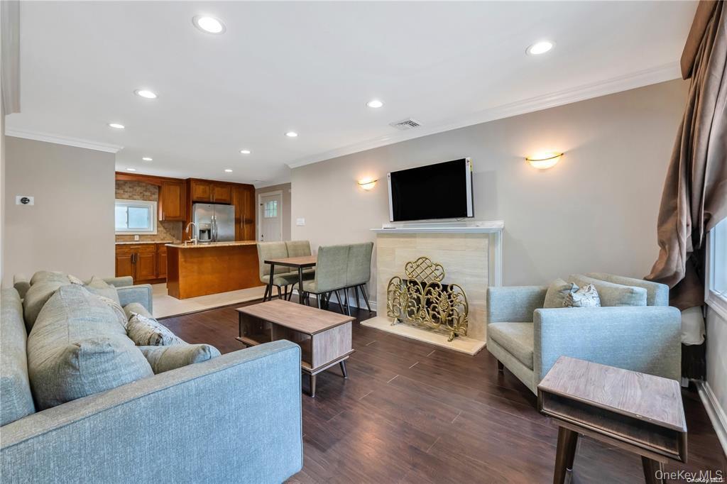 531 Old Country Road Plainview, NY 11803 - Photo 12 of 28 a living room with furniture a fireplace and a flat screen tv