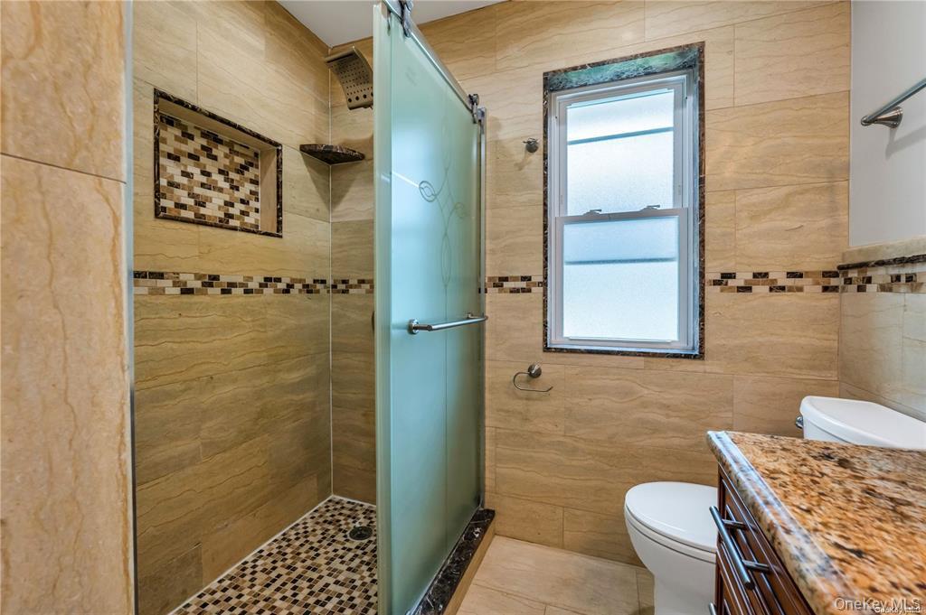 531 Old Country Road Plainview, NY 11803 - Photo 20 of 28 a bathroom with a sink and a mirror