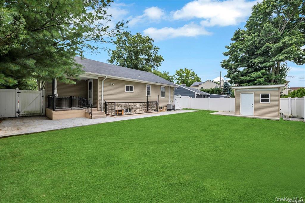 531 Old Country Road Plainview, NY 11803 - Photo 26 of 28 a view of a white house with a big yard and large tree