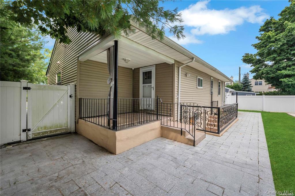 531 Old Country Road Plainview, NY 11803 - Photo 3 of 28 a view of a house with wooden fence and a floor to ceiling window