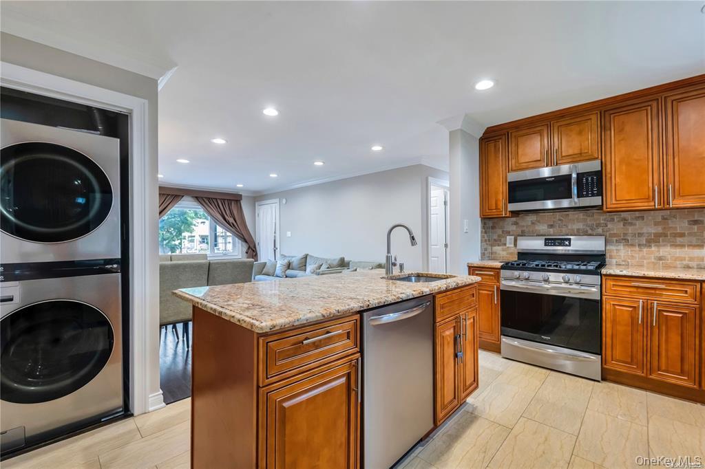 531 Old Country Road Plainview, NY 11803 - Photo 28 of 28 a kitchen with stainless steel appliances granite countertop a stove a sink and a microwave